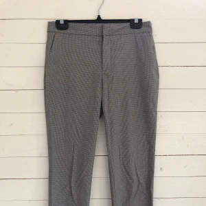 Svart/vita kostymbyxor från Zara i strl 36 - Svart/vita kostymbyxor i hundtandsmönser från Zara. Byxorna är ankellånga och har två fickor framtill. I storlek 36. Köparen står för frakt. 