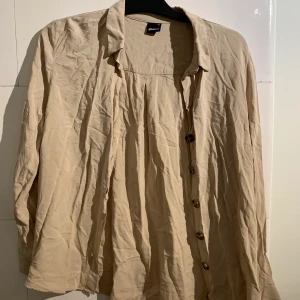 Beige skjorta från Ginatricot i storlek 40/L. - 74 kr med inkluderad frakt.