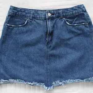 A short, blue, jean skirt - 100% cotton - made in Bangladesh 