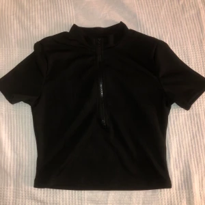 Topp med dragkedja - Säljer denna jättefina toppen i storlek S med en dragkedja i bröstet som man kan öppna om man vill för att har en massa andra liknande toppar. Den är aldrig använd endast testad och super fin. Kan mötas upp och frakta. Köparen står för frakten. (Tröjan är ej smutsig utan det är min spegel som är smutsig på bild 2)