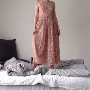 Spetsklänning pastell  - Ljusrosa spetsklänning med halterneck o lätt utställd kjol. Jag är 163 cm, klänningen mäter till halva smalbenet. superdrömmig o perfekt för fest, bröllop, you name it!  Aldrig använd. Nypris 800kr. Säljes 300kr. Upphämtas i malmö. 
