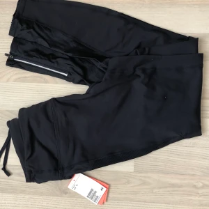 Träningstights  - Mörkblå/svarta träningstights från HM, aldrig använda o lappen är kvar, storlek M. Köptes för 249kr. Kan hämtas upp på Södermalm annars kostar frakt 33kr!