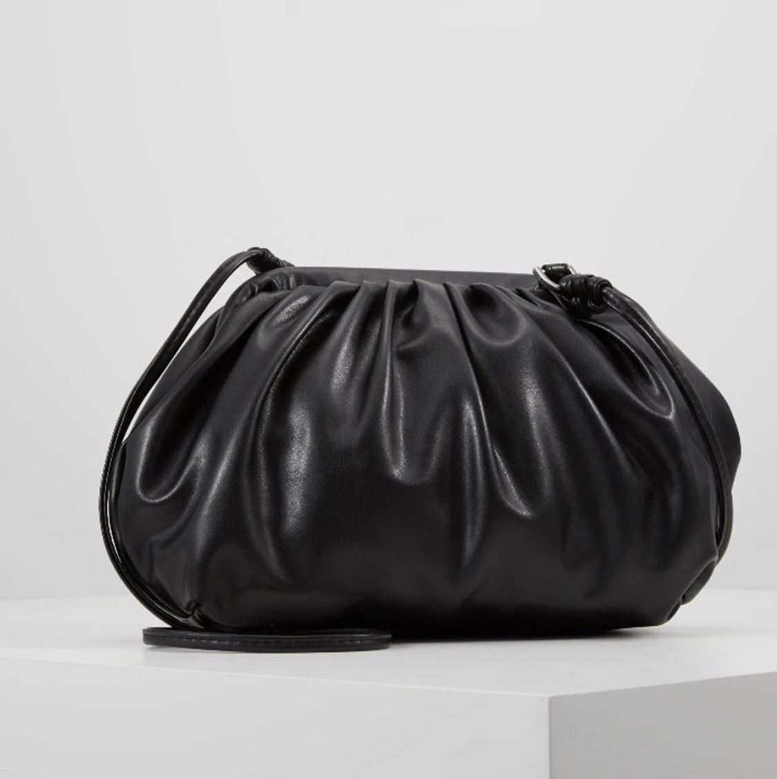 Tredig clutch med axelrem