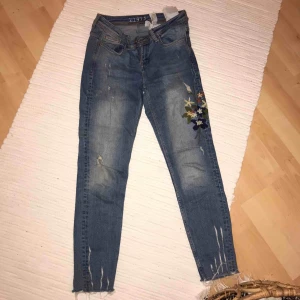  - Byxor med broderade blommor 