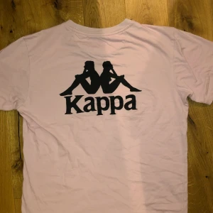 Rosa Kappa T-shirt - Ljusrosa kappa t-shirt med stort tryck på ryggen 