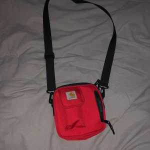 Carhatt-väska - Säljer min jättefina röda väska från carhatt. Jättefint skick och säljer pga av arts en inte kommer till användning. Köpte den för 350 kr. Fraktar endast (köparen får stå för frakten 63 kr)