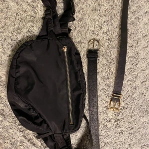 Midjeväska + 2 skärp  - Midjeväska från Monki, rymmer väldigt mycket grejer. 2 skärp från hm ett silver och ett guld. Pris kan diskuteras.