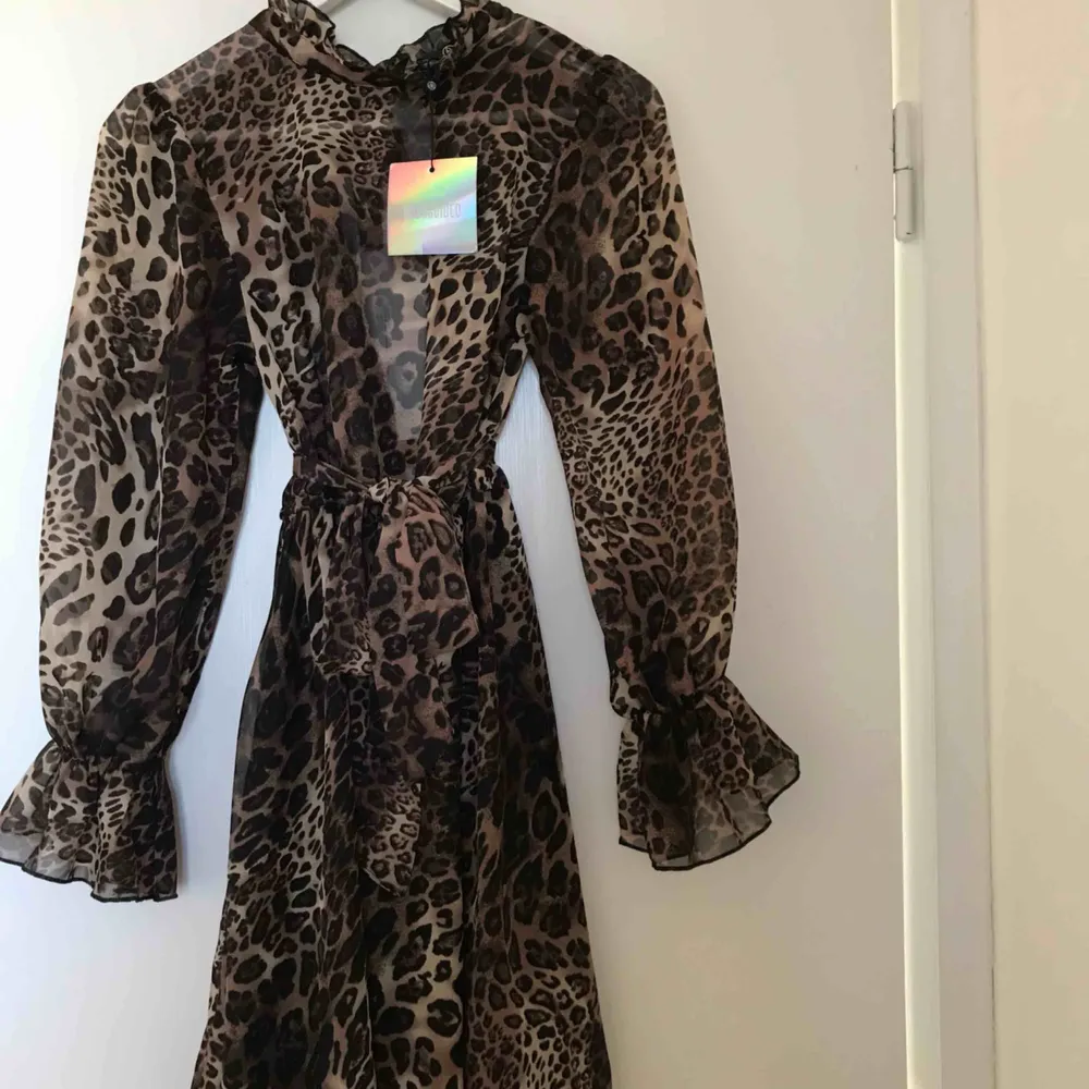Snygg leopardklänning inköpt denna säsong från missguided. Strl 4 (XS), Säljes pga fel storlek. Aldrig använd, prislapp sitter kvar. Länk till produktsidan: https://www.missguided.co.uk/high-neck-tie-waist-smock-dress-leopard-1”. Klänningar.