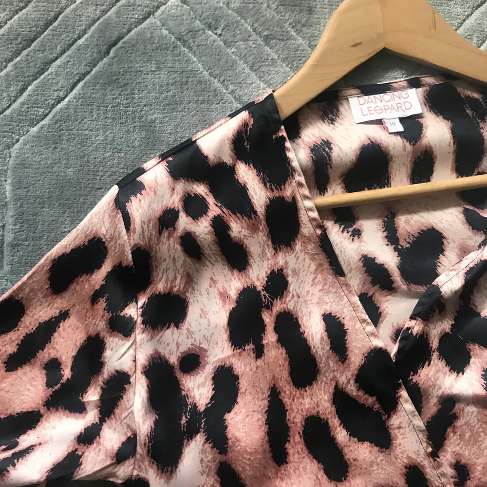 Vacker helt oanvänd Omlottklänning i ljusrosa Leo-print från dancing leopard. Eftersom det är en omlottklänning så passar den både en small och medium men är en uk strl 10 och svensk 38. . Klänningar.