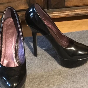  - 2 par lackskor med ca 15 cm klack. Svarta + klarröda