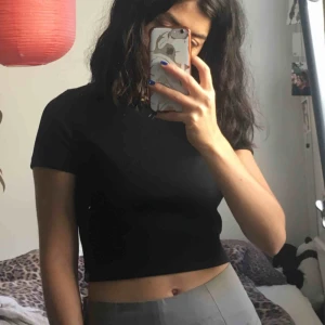  - Svart croptop från Monki i ribbat glansigt material. Storlek XS och inte så stretchigt tyg. Köpt på loppis men knappt använd av mig. Gott sick!  Kan mötas i Stockholm eller frakta, köparen står då för frakt. 