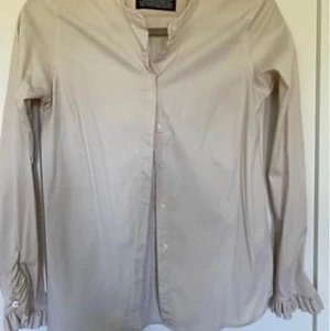 Mos Mosh Skjorta/blus - Snygg skjorta/blus, färg ljus beige.  Snygg detalj nere vid ärmslutet. 