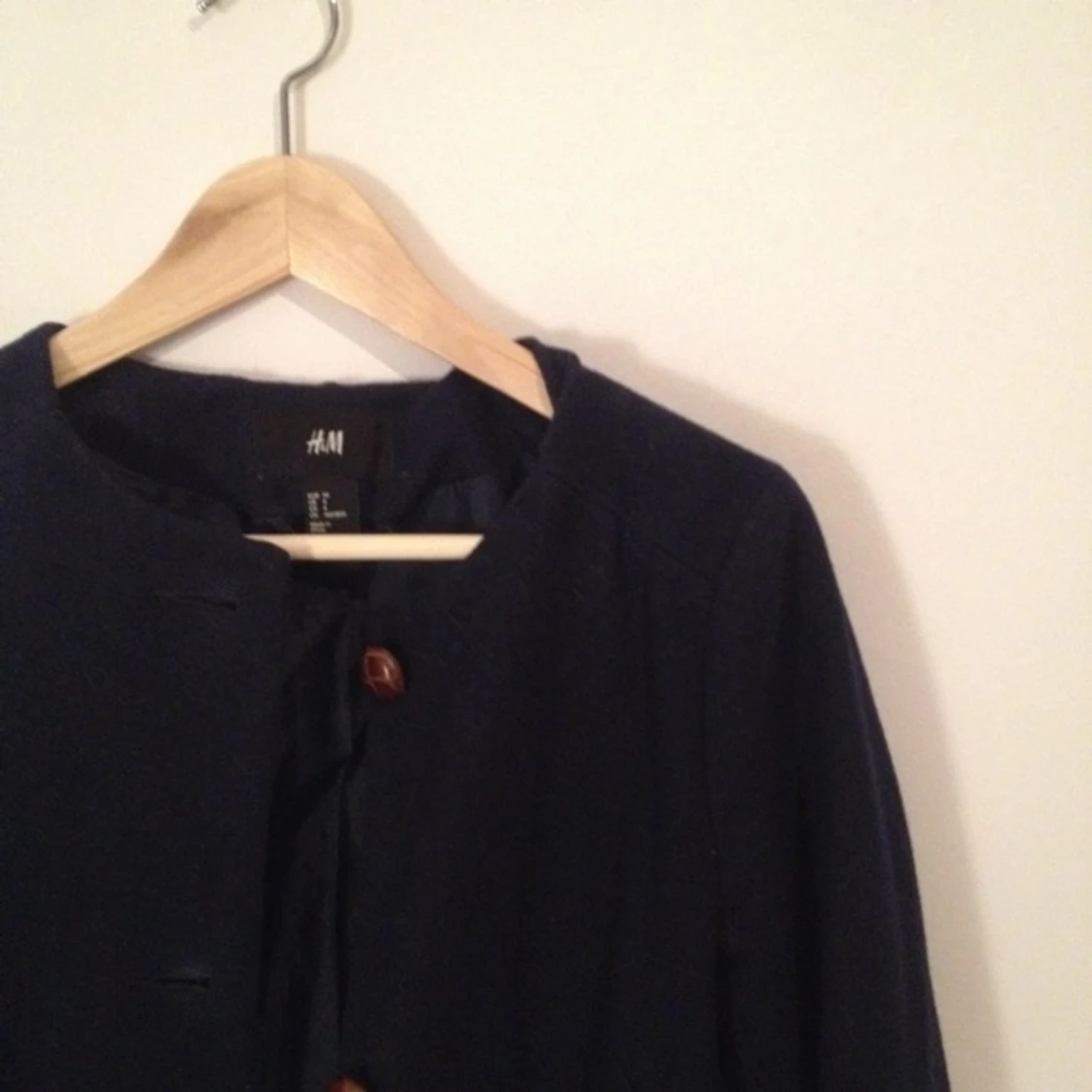 mörkt marinblå hm trend kappa med bruna stora knappar. 60% återvunnen ull, 30 polyester - 1387223172