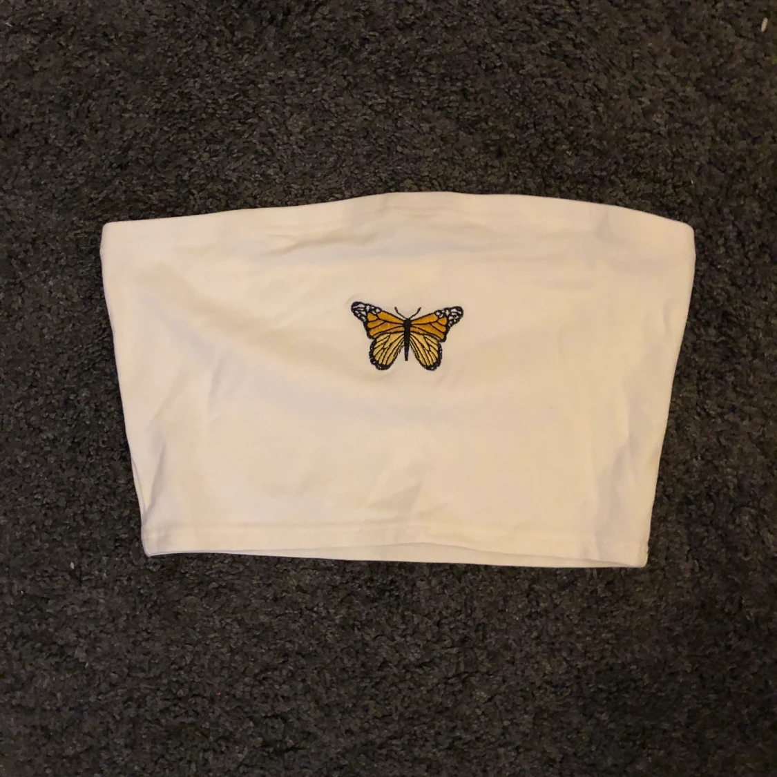 Vit topp med fjäril