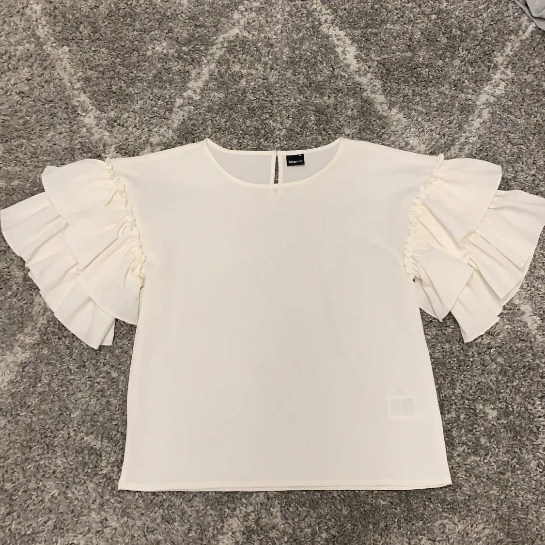 Vit stilig blus med volanger vid ärm