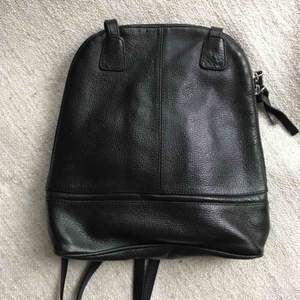 Black soft leather mini-bag. Perfect condition. Lots of pockets. Shipping is extra.