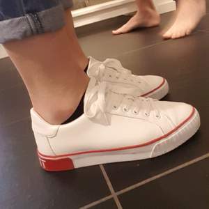 Vita sneakers med röda detaljer från Esprit i storlek 38. Obetydligt använda. 