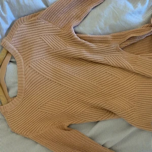 Stickad tröja med öppen rygg - Säljer denna fina tröjan med en öppen rygg och en slits på varje sida sida. Har inte haft problem med att bh-band osv syns i ryggen, den är även väldigt varm så trots den öppna ryggen fungerar den toppen att ha på vintern/hösten. Har ärvt den så vet inte vart den kommer ifrån eller vad storleken är. Däremot skulle jag verkligen säga att den passar alla, det beror mest på hur man vill att den ska sitta. Jag själv är en XS/S och den är lite lång på mig ☺️☺️ Den är inte nopprig eller något och endast använd av mig ca 2-3 gånger!