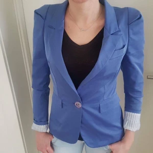  - En blå kavaj i ett bra skick.