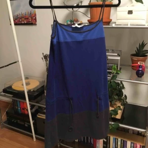  - En blå/mörkblå/grå klänning med ett spänne runt höfterna. Perfekt att gå till stranden med eller ha över en långärmad tröja eller t-shirt. Priset är inkluderat frakt.