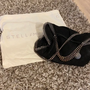 Stella mccartney väska - Säljer min stora Stella McCartney väska som tyvärr inte kommer till användning längre. Modell: Falabella Tote Bag. Mycket bra skick förutom kedjorna som tyvärr börjat tappa färg(se bild). Annars inga slitningar varken på eller inuti. Nypris ca 8000kr. Möts endast upp i Stockholm💕