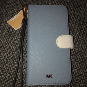 Michael Kors - Äkta, aldrig använd Michael Kors mobilfodral med prislappen kvar, köpt i Michael Kors butiken i Köpenhamn. Köparen står för eventuell frakt. Passar IPhone 8Plus och IPhone 7Plus. 