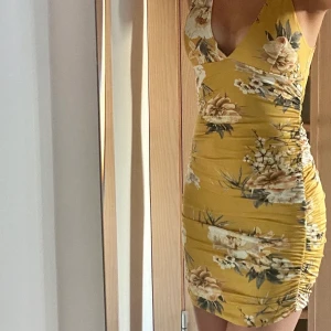 Klänning - Stretchig och ruched klänning med flowerprint, från Missguided. Aldrig använd!