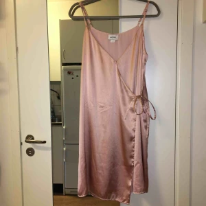  - Omlottklänning från Monki med tunna band. 100% polyester. Använd endast vid ett tillfälle.  Kan mötas upp alt. skicka.