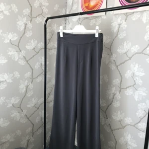 Vida raka byxor - Vida raka byxor med fin passform från bikbok. Liknar kostymbyxor i materialet.