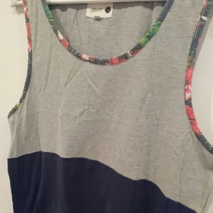  - Humör linne med blommigt mesh tyg i ärmmudden.
grå & mörkblå