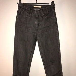  - Levi's - 721 High Rise Skinny, Grå Stl 24/32  87% Bomull 12% Polyester 1% Elastan Ett år gamla endast använda två gånger - Fint skick!