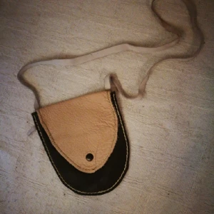  - Cute little leather bag/pouch. Hand made item. The leather is rather soft to the touch and the colours are dark brown and light pink.