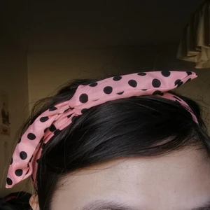 Hårband prickigt rosa/svart  - Hårband i 50-tals  rockabilly och pinupstil! Har metalltråd inuti som gör så att du bättre och stabilare kan styla/forma bandet precis så som du vill att det ska sitta. Frakt tillkommer. 