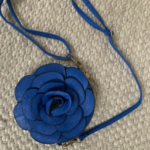 Blä läderväska  - Supergullig liten blå handväska med en ros av läder utanpå. 💙💙 Använd men bra skick! ✨🤪 Skriv för fler bilder (: