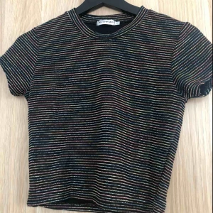  - Svart glittrig tröja med färgglada ränder köpt från UO för ca 300kr, köparen står för frakt