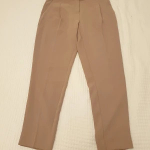 Beige sköna kostymbyxor!  - Sköna och snygga kostymbyxor i beige med skärp i midjan. 