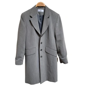 Grå lång kappa - En medellång, tunn och grå kappa i storlek 10, motsvarar 36. Perfekt nu till hösten! Så fin, men har tyvärr överflöd i kappor 🦋