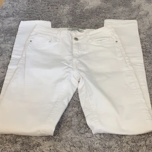 White jeans - White skinny  jeans with pockets in front. The are stretchy and midrise 