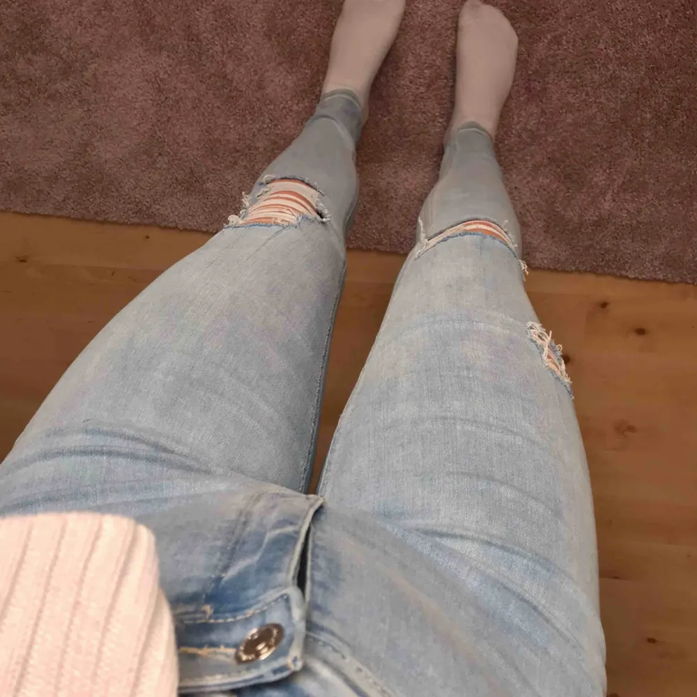 Ljusblåa fina jeans med hål i. Storleken är i L men är väldigt stretchiga vilket gör att de passar mig som vanligtvis har S/M i byxor. . Jeans & Byxor.