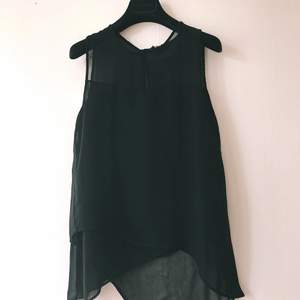 Asymmetrical black top in sheer material, from H&M, size 36, in very good condition