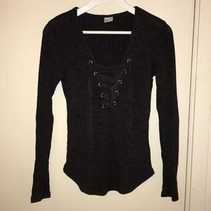 Mörkgrå ribbstickad tröja från Gina Tricot.