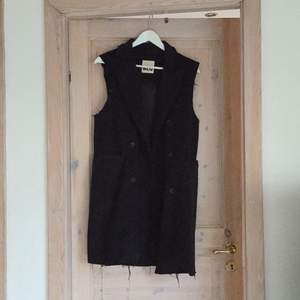Long, black vest. Bought ripped and torn from Nasty Gal, only worn twice. 