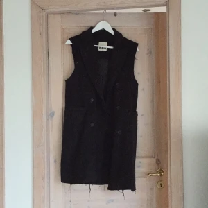  - Long, black vest. Bought ripped and torn from Nasty Gal, only worn twice. 