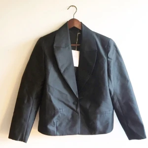  - Black blazer/jacket with one button closure designed by Lykke Li for And Other Stories.  Androgyn fit with shoulder pads. Shell; 51% wool, 49% silk. Lining; 52% polyester, 48% rayon. Great condition, never used. Bought it for 1450.
