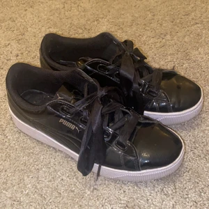 Puma sneakers - Jättesöta puma skor som är svarta och i storlek 39. Det är en hög vit sula och skon har ett lack material så det är glansigt. Söta snören som är lite bredare som gör skorna lite mer speciella! Sulorna i skorna är jättesköna och mjuka men säljer pga det inte längre är min stil. Inte alls så slitna och är i fint skick, fungerar bra i regn pga materialet och är lätta att tvätta💞 fraktar eller möts upp i Stockholm