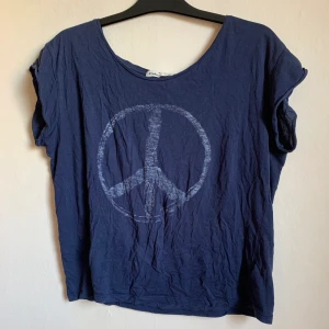 Peace t-shirt - Snygg marinblå t-shirt med peace märke. 