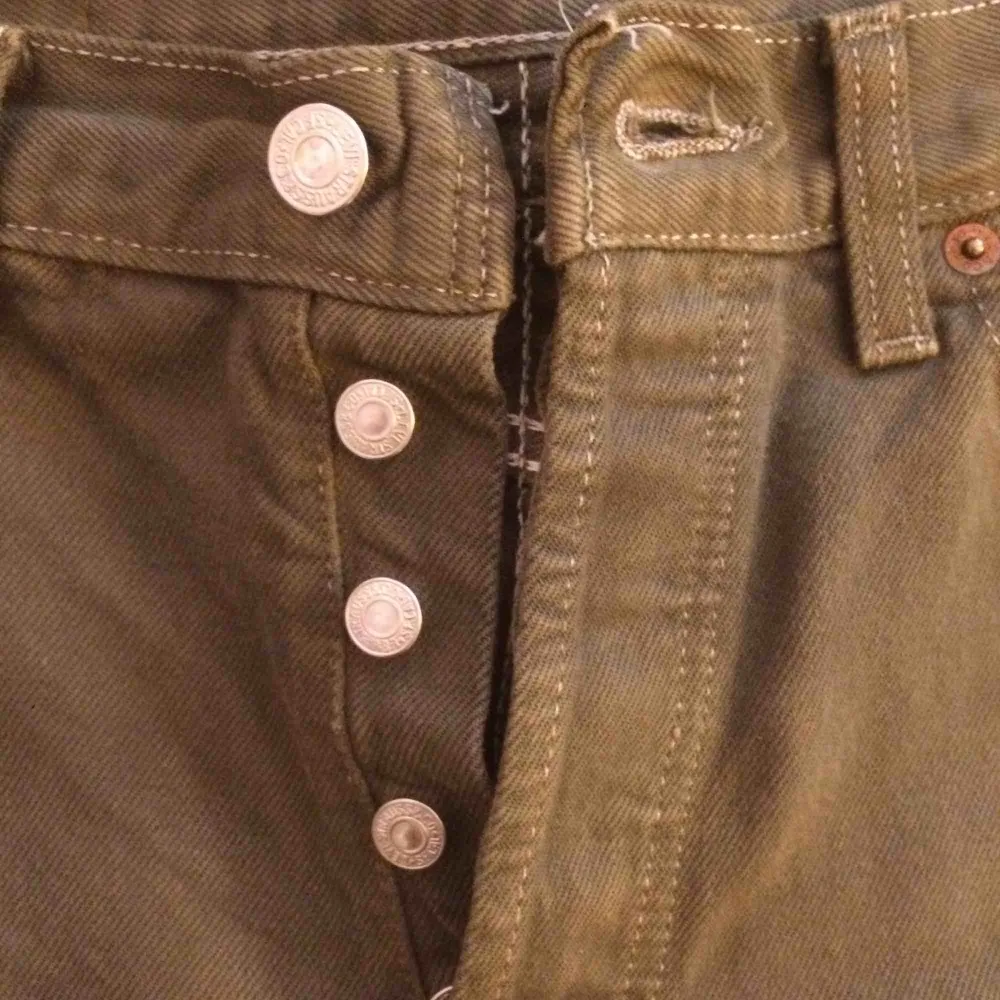 Ett par militärgröna levi’s jeans, väldigt bra skick, knappar i stället för gylf. Jeans & Byxor.