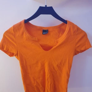 Orange topp - Helt oanvänd topp från gina tricot med en unik urringning! Denna är fraktfri och är i storlek Xs!💓 skriv gärna om du vill ha fler bilder!