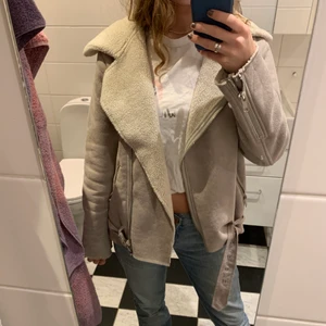 Bikerjacka med fårskinns imitation  - En beige bikerjacka med fårskinns imitation köpt i scottland från ett märke som heter Farrow. Använd några gånger förra vintern och är både varm och snygg. Fickor på båda sidorna med dragkedja och spänne både nere och uppe vid kragen. Hör av er vid frågor eller vill ha mer bilder:) 