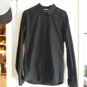  - Man Black shirt Celio. Dress up shirt very good status. Have been use only few time. Size L slim fit